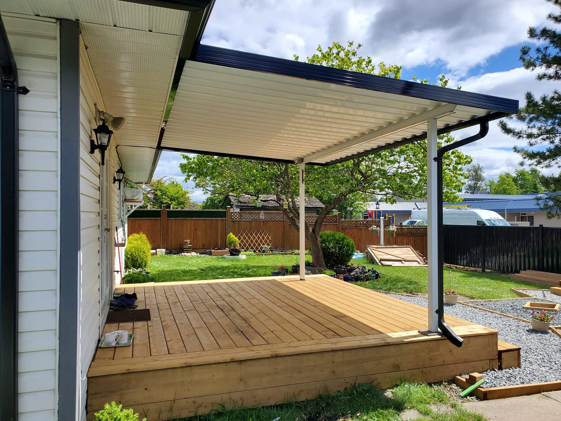 White aluminum patio cover over a backyard deck