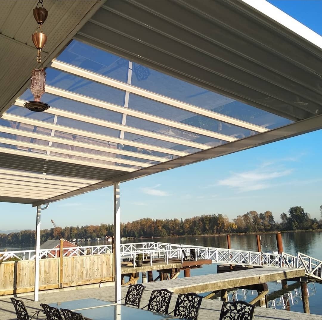 Aluminum pergola cover over a waterfront dining deck
